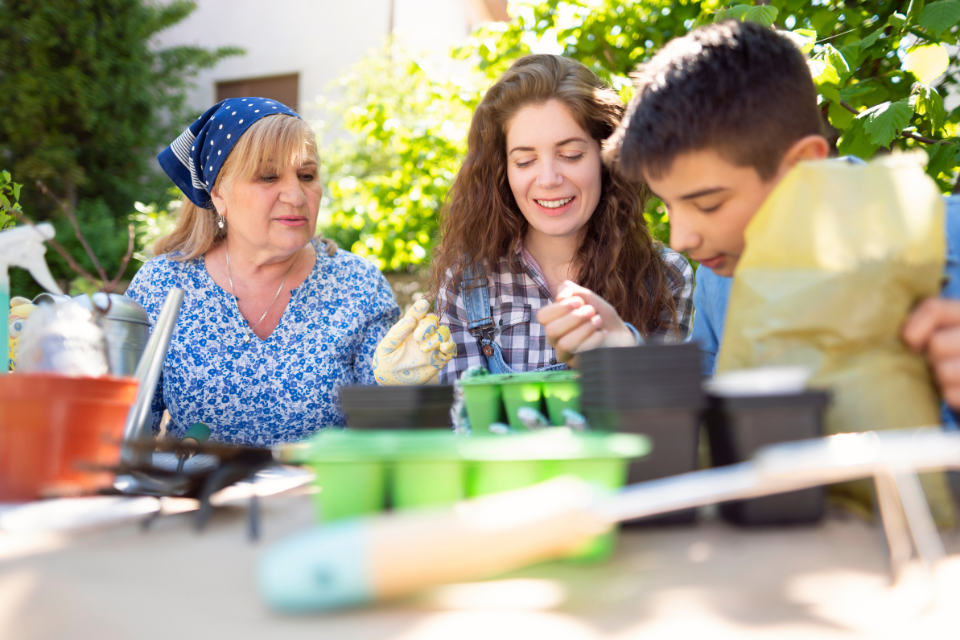 three people gardening together